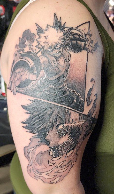 Black and grey anime panels on an upper arm