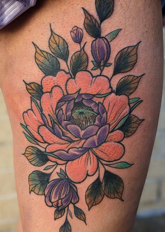 Neo traditional peony in coral and purple on a thigh